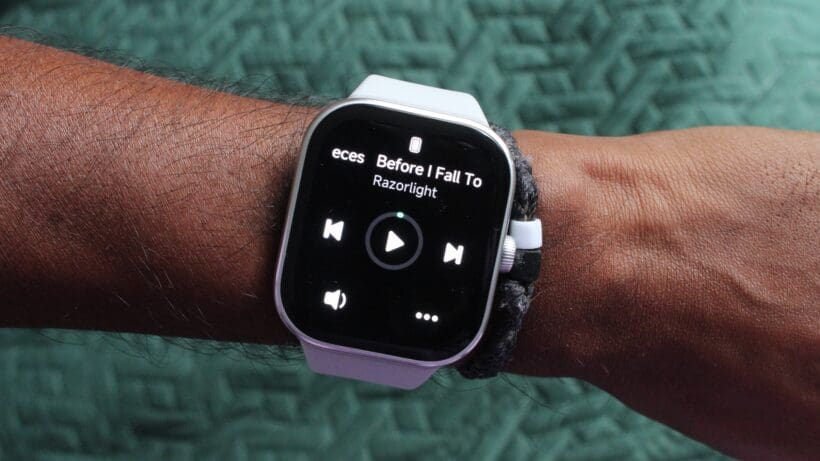 Redmi Watch 5 on wrist showing music control