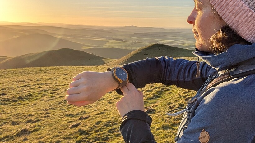 wide angle shot of hiker wearing a garmin watch